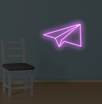 Modern wall with paper plane LED neon sign glowing purple.