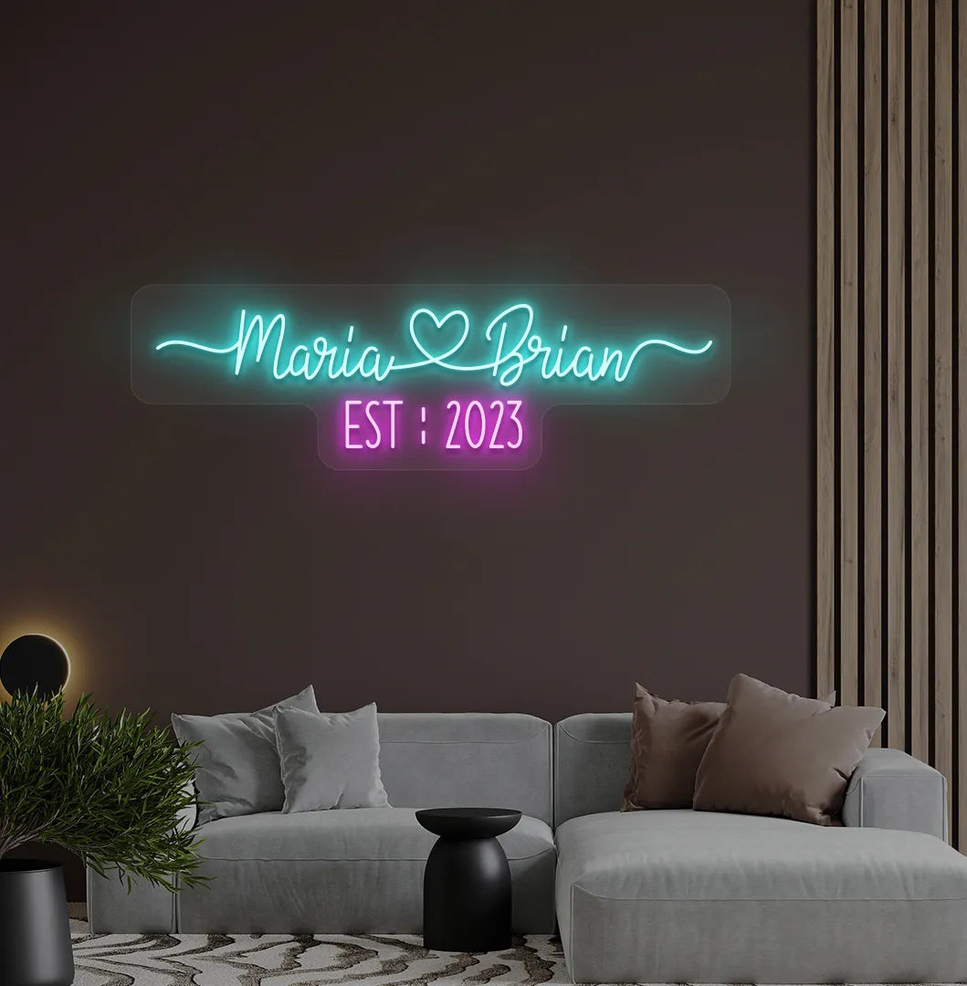 Romantic custom Couple Name EST neon sign glowing ice blue on aesthetic wall.