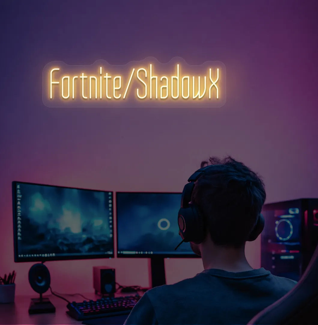 Modern gaming setup featuring Personalized Game and Name blue neon sign in orange color.