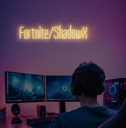 Modern gaming setup featuring Personalized Game and Name blue neon sign in orange color.