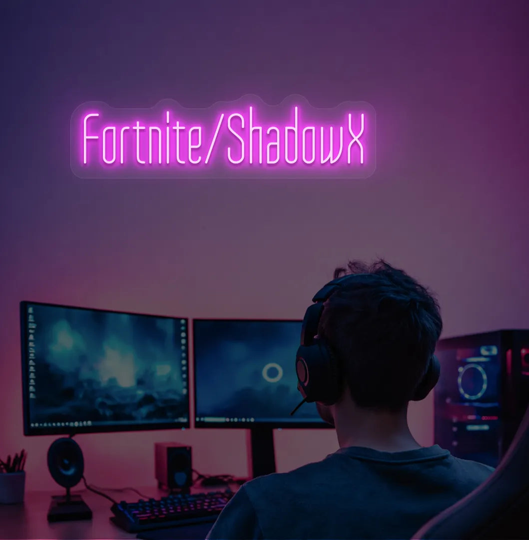 Pink LED Personalized Game and Name neon sign glowing on gaming room wall.