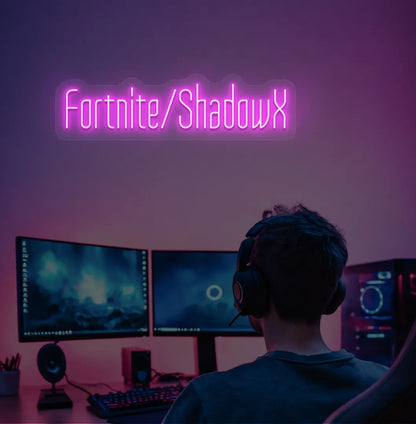 Pink LED Personalized Game and Name neon sign glowing on gaming room wall.