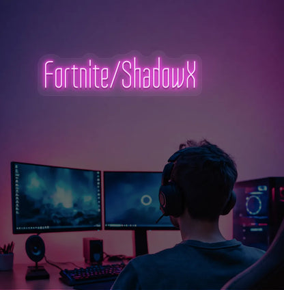 Modern gaming setup featuring Personalized Game and Name blue neon sign in purple color.
