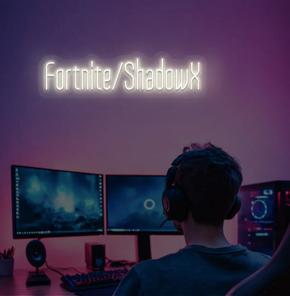 Modern gaming setup featuring Personalized Game and Name blue neon sign in warm white color.