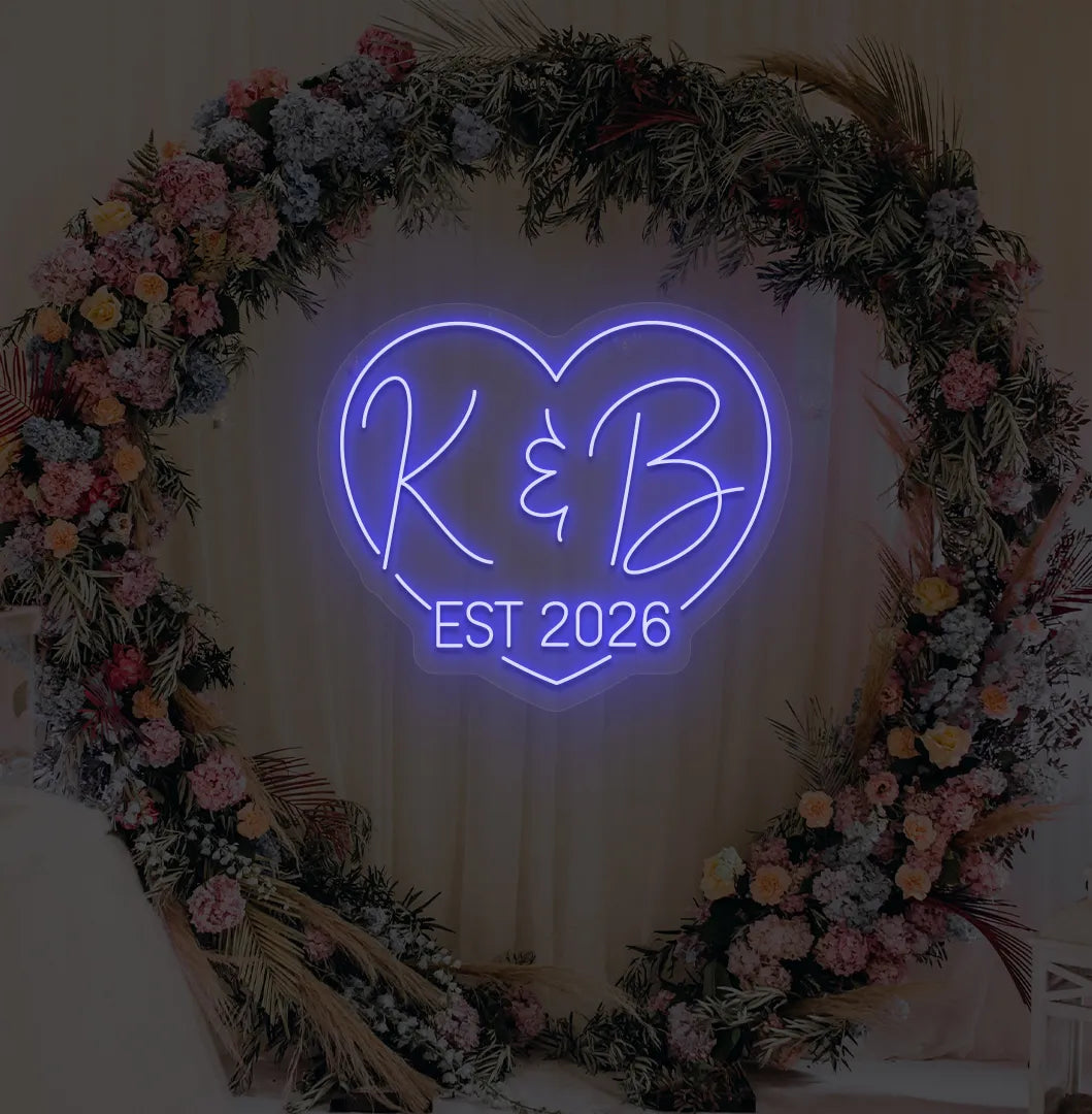 Personalized wedding established neon sign glowing blue on decorative wall.