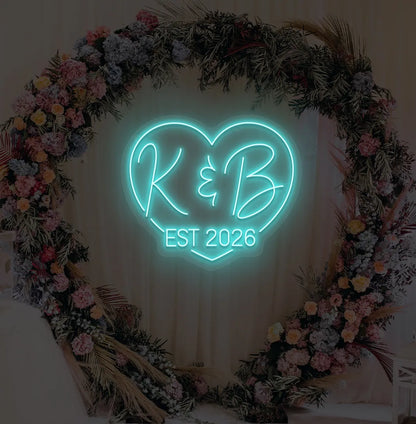 Personalized wedding established neon sign glowing ice blue on decorative wall.