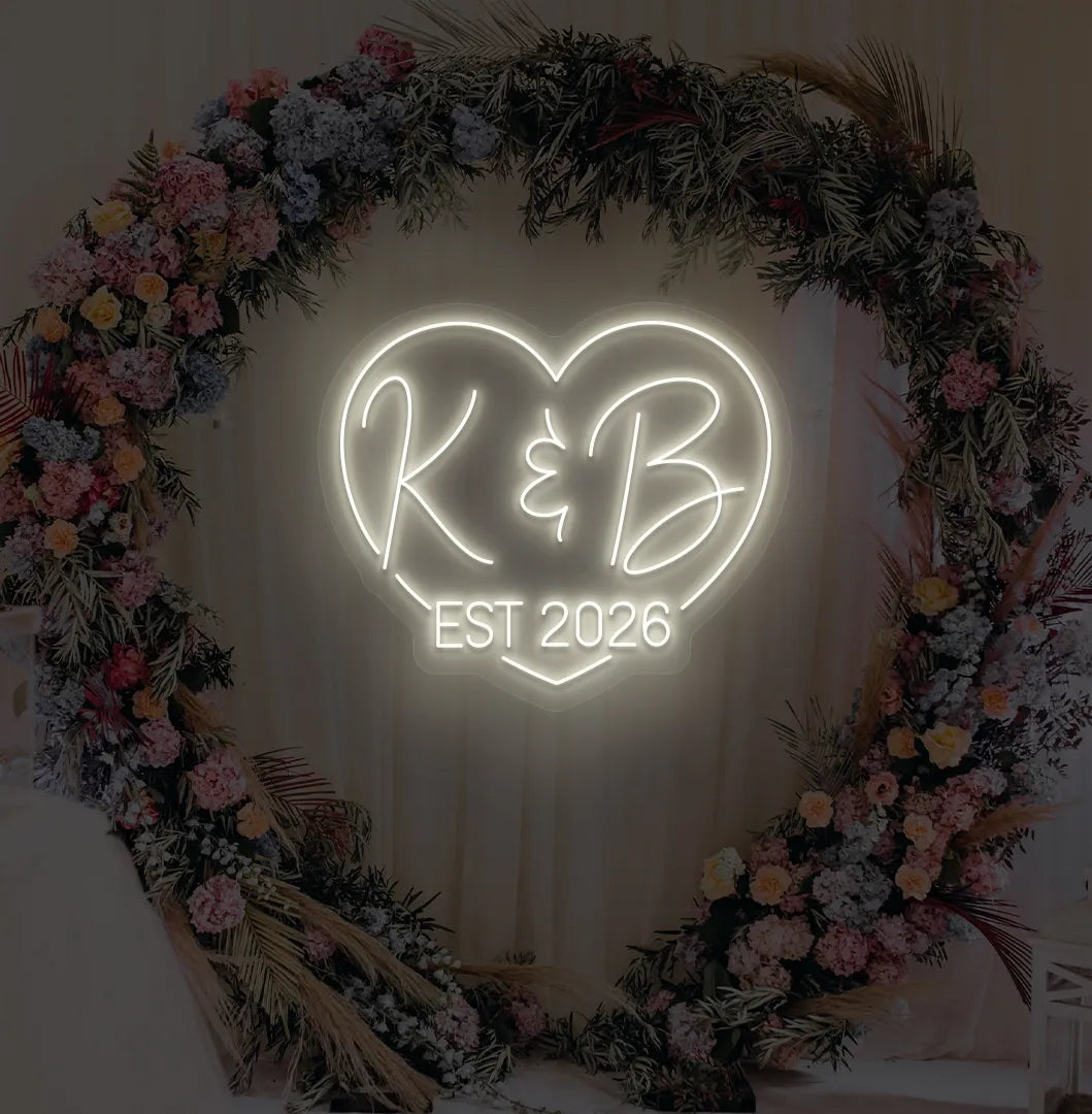 Image of a custom wedding EST neon sign in warm white color on aesthetic wall decor.