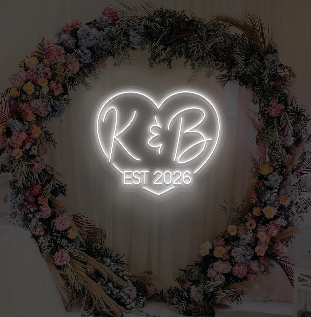 Personalized wedding established neon sign glowing white on decorative wall.
