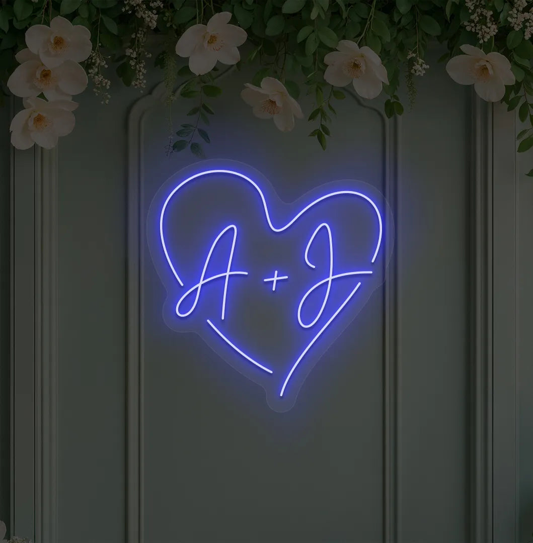 Personalized wedding initials neon sign glowing blue on wedding backdrop.