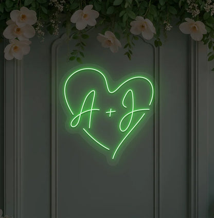 Image of a personalized wedding initials neon sign glowing green on decorative wall.