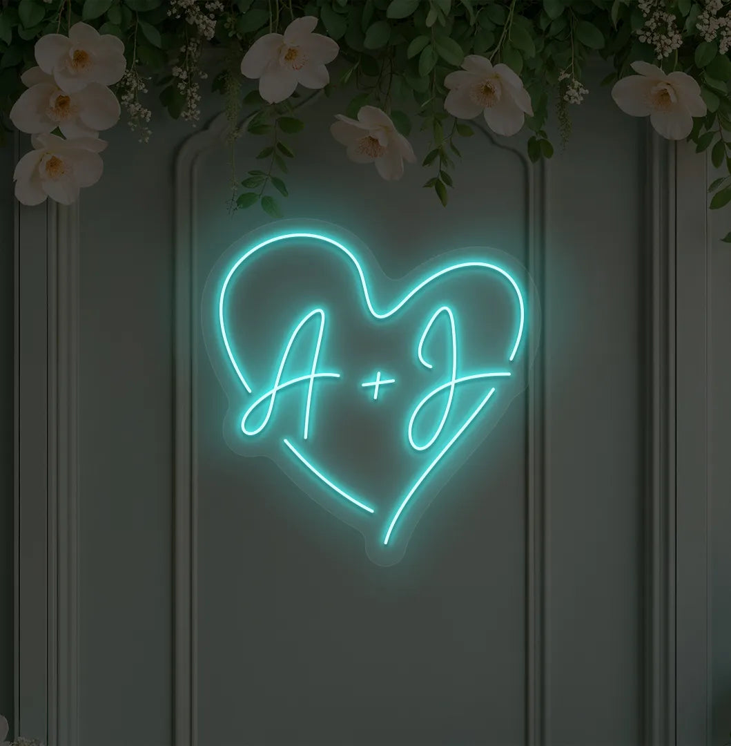 Personalized wedding initials neon sign glowing ice blue on wedding backdrop.