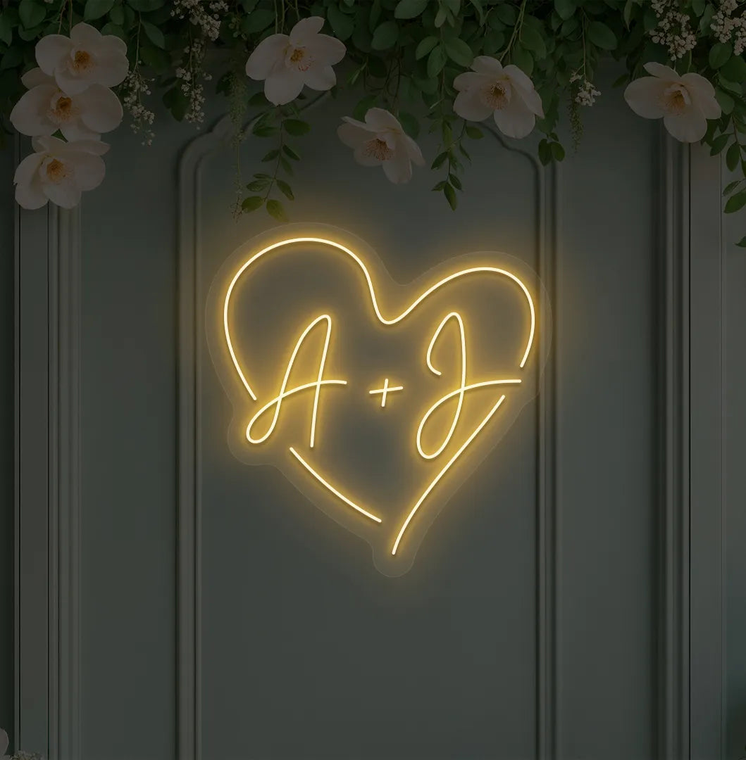 Image of a personalized wedding initials neon sign glowing orange on decorative wall.