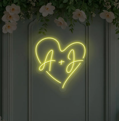 Image of a personalized wedding initials neon sign glowing yellow on decorative wall.