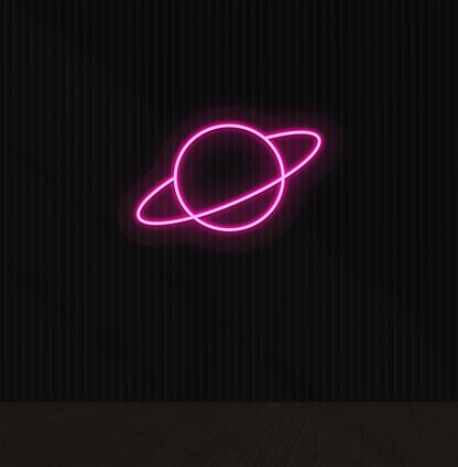A space-themed planet LED neon sign glowing pink on the wall.