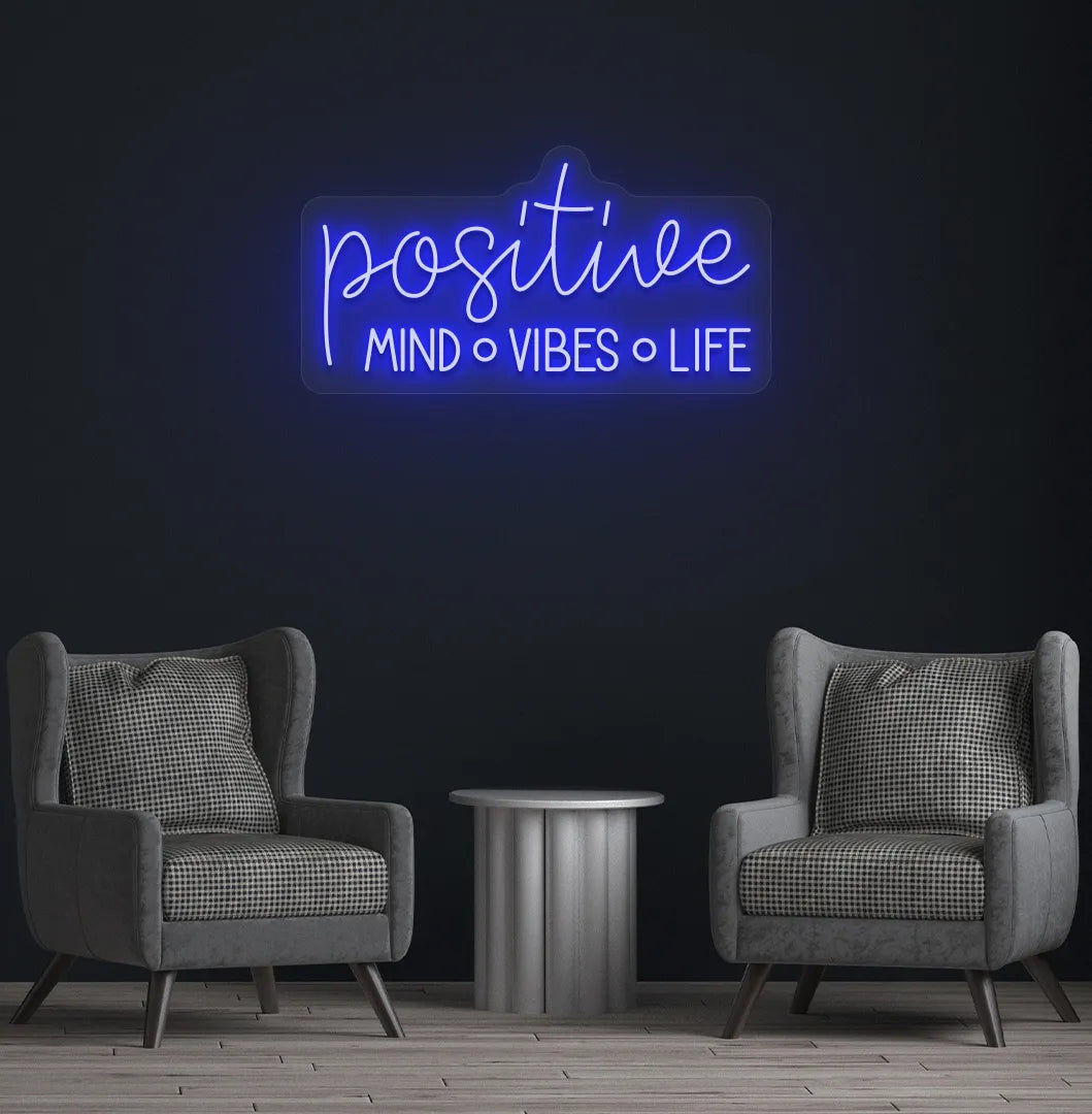 Inspirational Positive Mind Vibes Life neon sign glowing blue on modern wall.