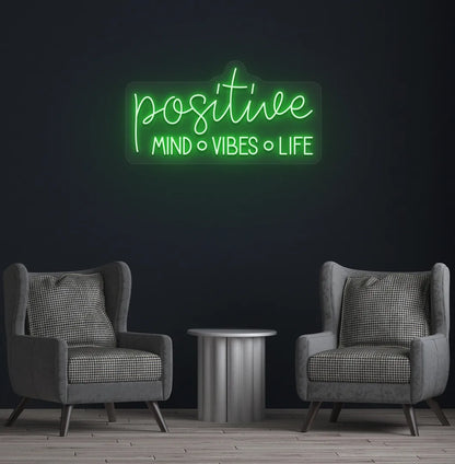Stylish Positive Mind Vibes Life neon sign mounted on aesthetic room wall in green color.