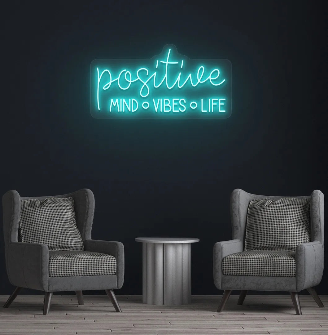 Inspirational Positive Mind Vibes Life neon sign glowing ice blue on modern wall.