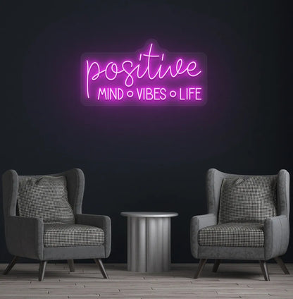 Inspirational Positive Mind Vibes Life neon sign glowing pink on modern wall.