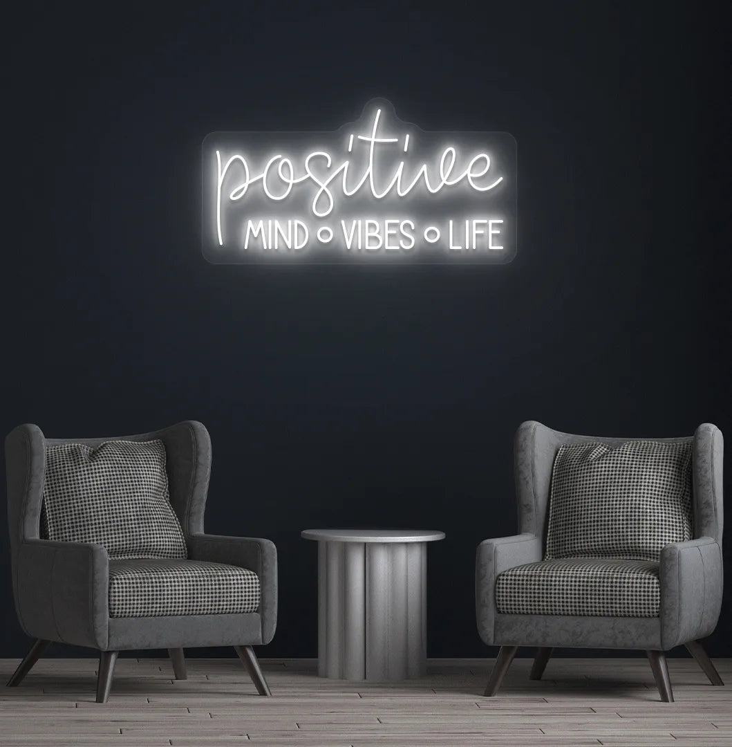 Inspirational Positive Mind Vibes Life neon sign glowing white on modern wall.