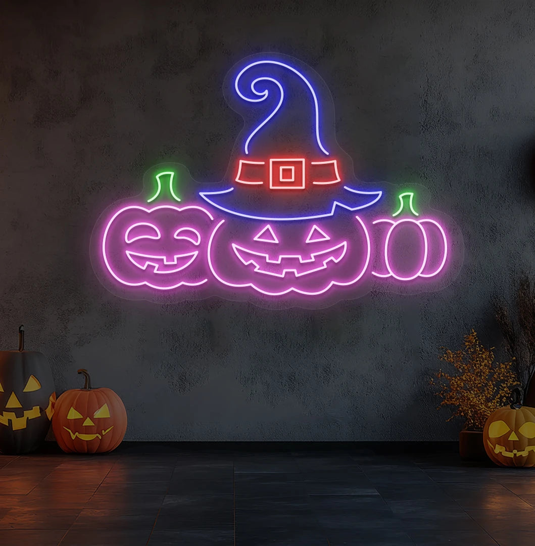 Modern wall decor with pumpkins Halloween neon sign glowing pink.
