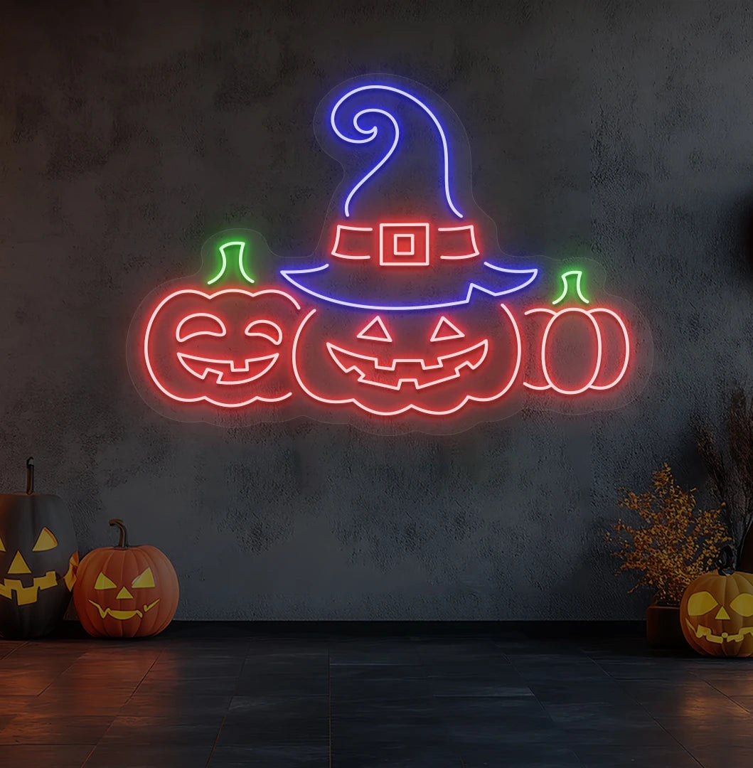 Modern wall decor with pumpkins Halloween neon sign glowing red.