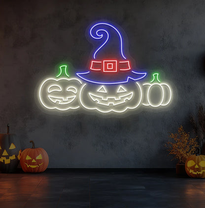 Spooky pumpkins Halloween neon sign in warm white mounted on room wall.