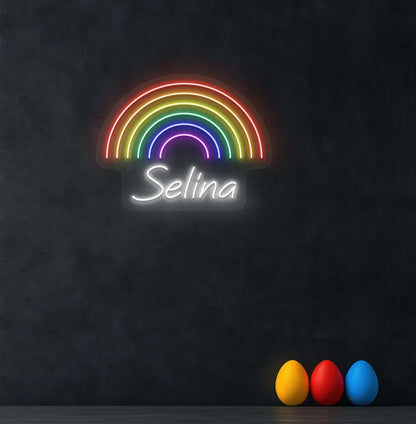 Personalized Rainbow Name neon sign in white color mounted on modern wall.
