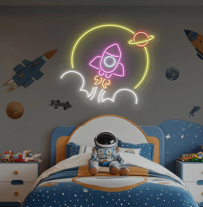 Image of a rocket neon sign in space theme above astronaut toy glowing on kid's room wall in pink color.