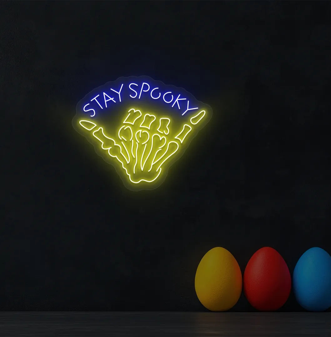 Blue Skeleton Hand Neon Sign glowing on a spooky Halloween themed wall.