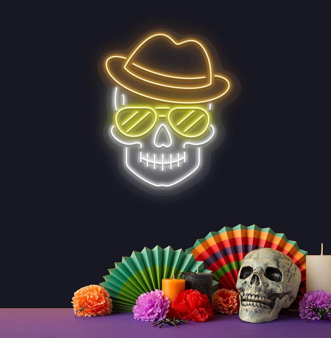 Modern aesthetic wall with skull neon sign glowing orange above human skull.