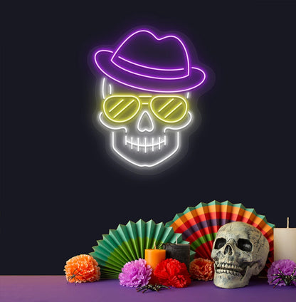 Modern aesthetic wall with skull neon sign glowing purple above human skull.