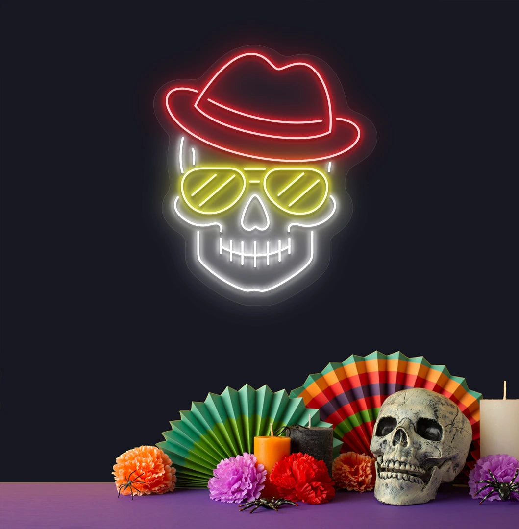 Image of a skull with hat and sunglasses neon sign above human skull glowing on wall in red color.