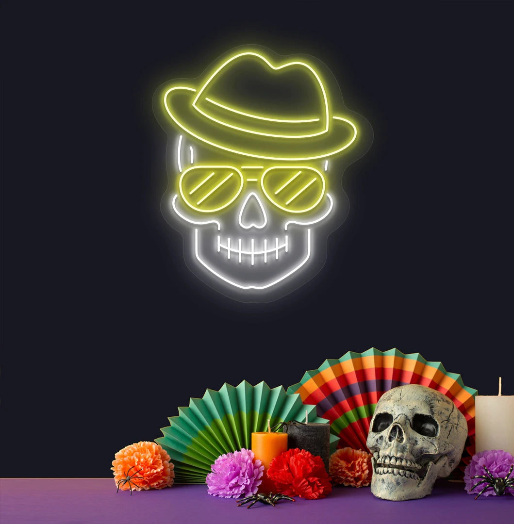Modern aesthetic wall with skull neon sign glowing yellow above human skull.