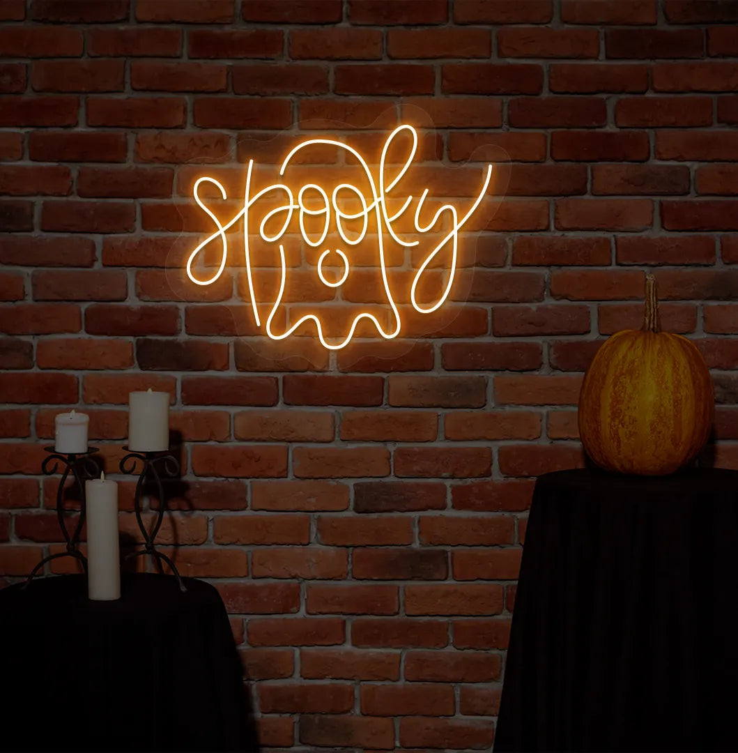 Spooky Orange Neon Sign creating an eerie glow on a Halloween themed wall.