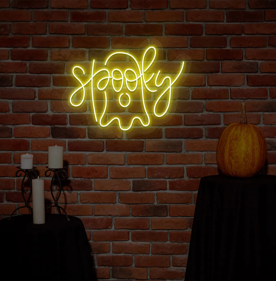 Spooky yellow Neon Sign creating an eerie glow on a Halloween themed wall.