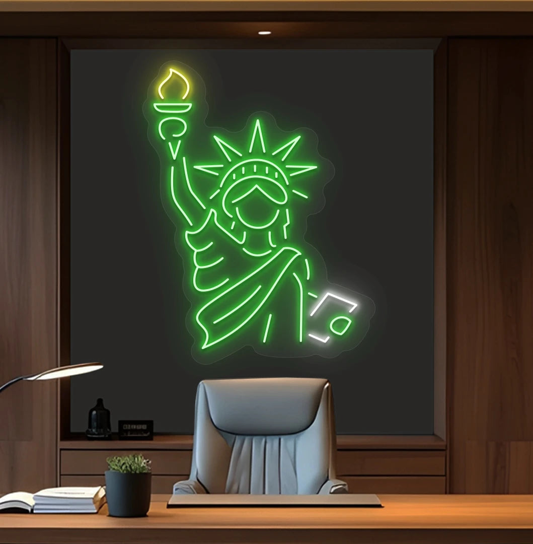 Modern office wall with statue of liberty neon sign glowing green behind chair.