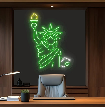 Modern office wall with statue of liberty neon sign glowing green behind chair.