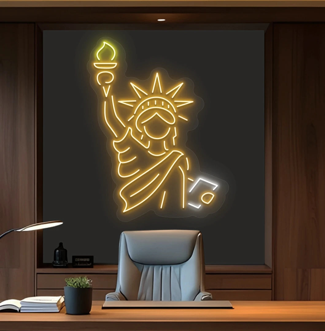 Modern office wall with statue of liberty neon sign glowing orange behind chair.
