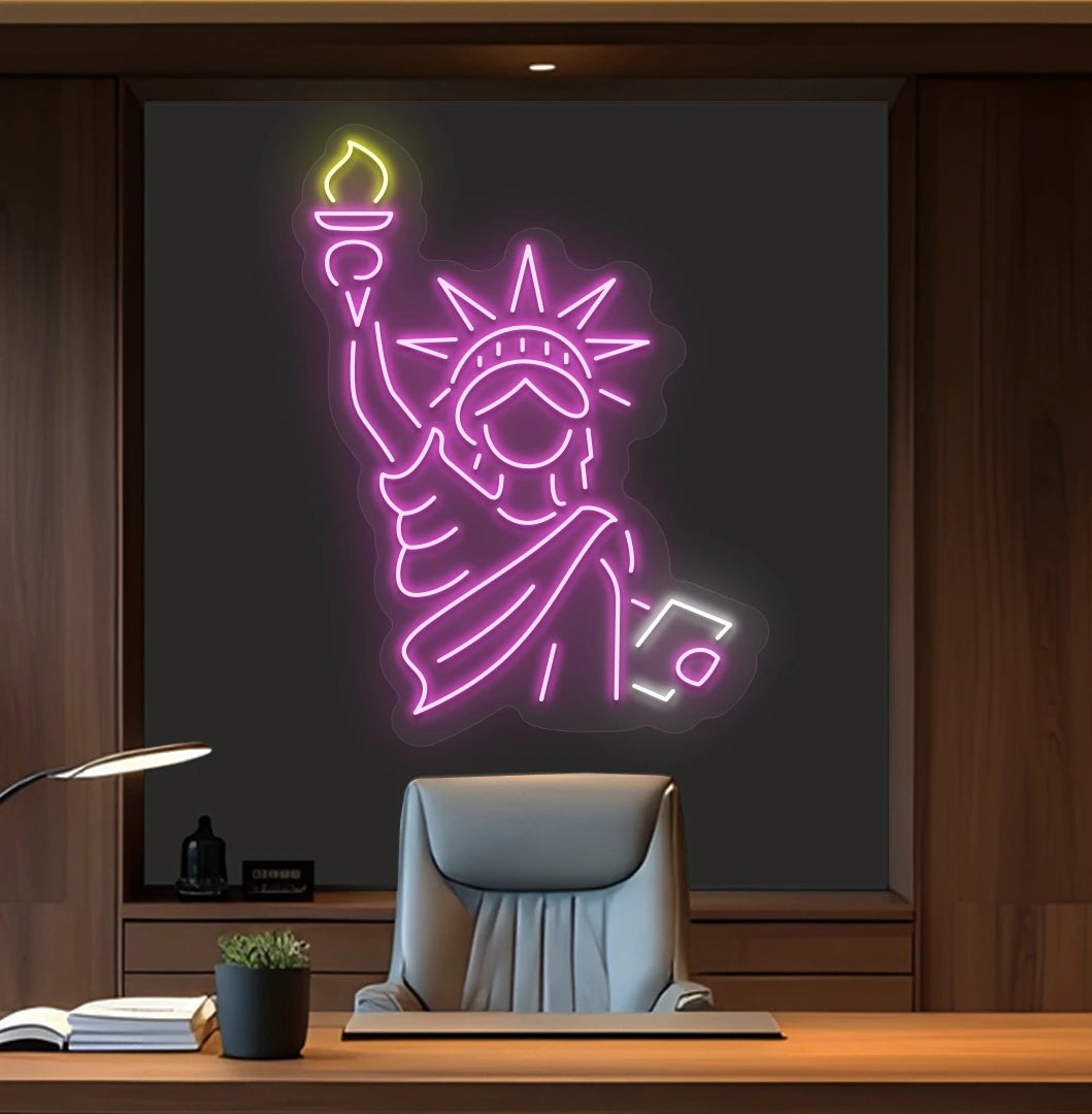 Image of a "Statue of Liberty" neon sign mounted on office wall in pink color.