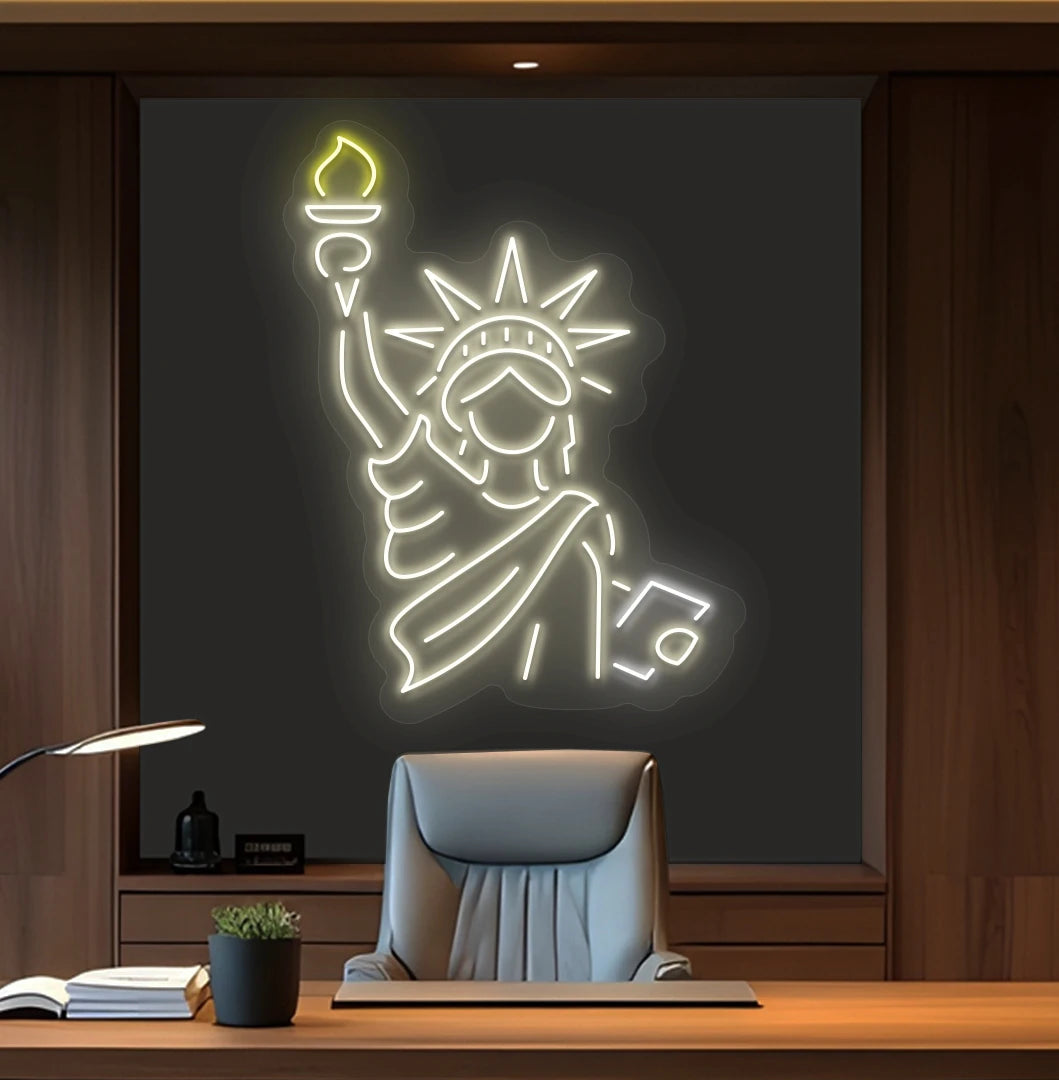 Modern office wall with statue of liberty neon sign glowing warm white behind chair.