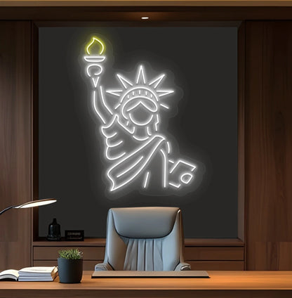 Image of a "Statue of Liberty" neon sign mounted on office wall in white color.