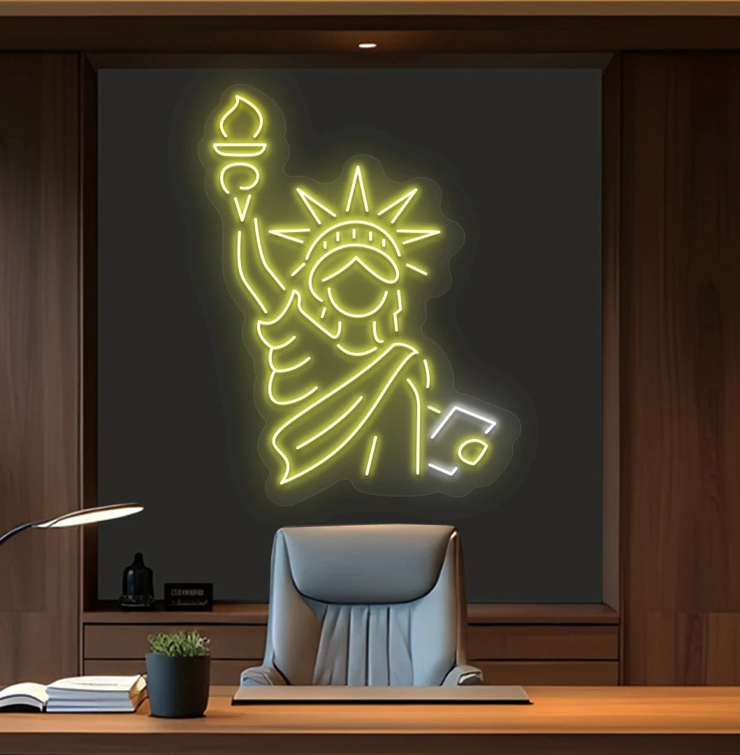 Modern office wall with statue of liberty neon sign glowing yellow behind chair.