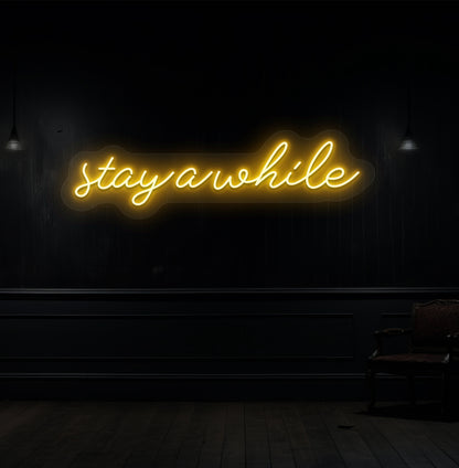 Decorative orange neon sign "stay a while" on a wood panel wall. Perfect for living room & hallway décor, cafés, lounges, and reception spaces.