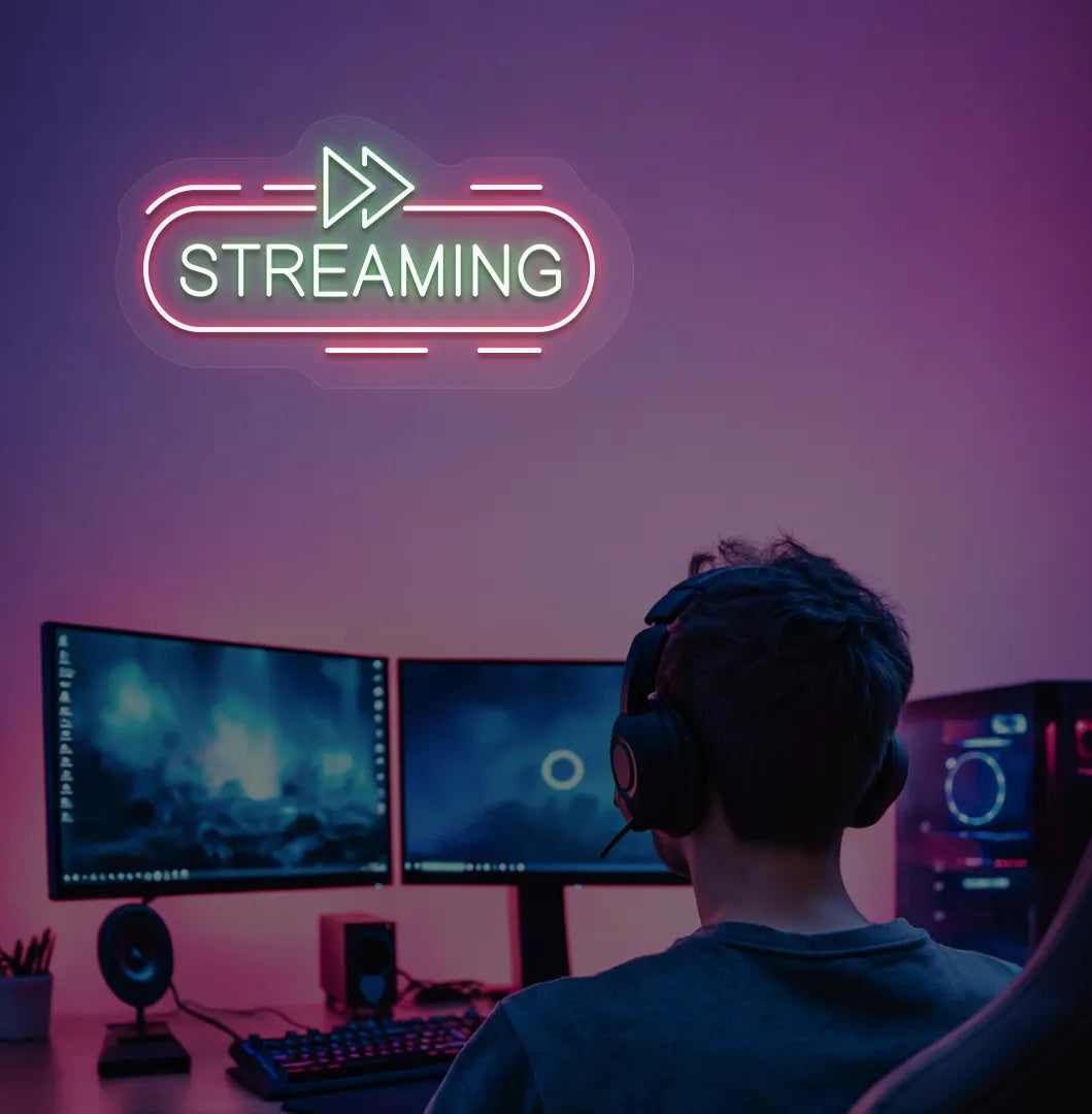 Stylish streaming neon sign in green mounted on gaming room wall.