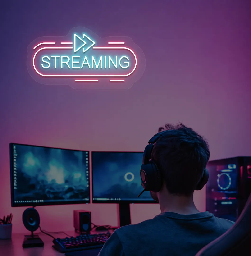 Image of a "streaming" neon sign in ice blue color mounted on gaming room wall.