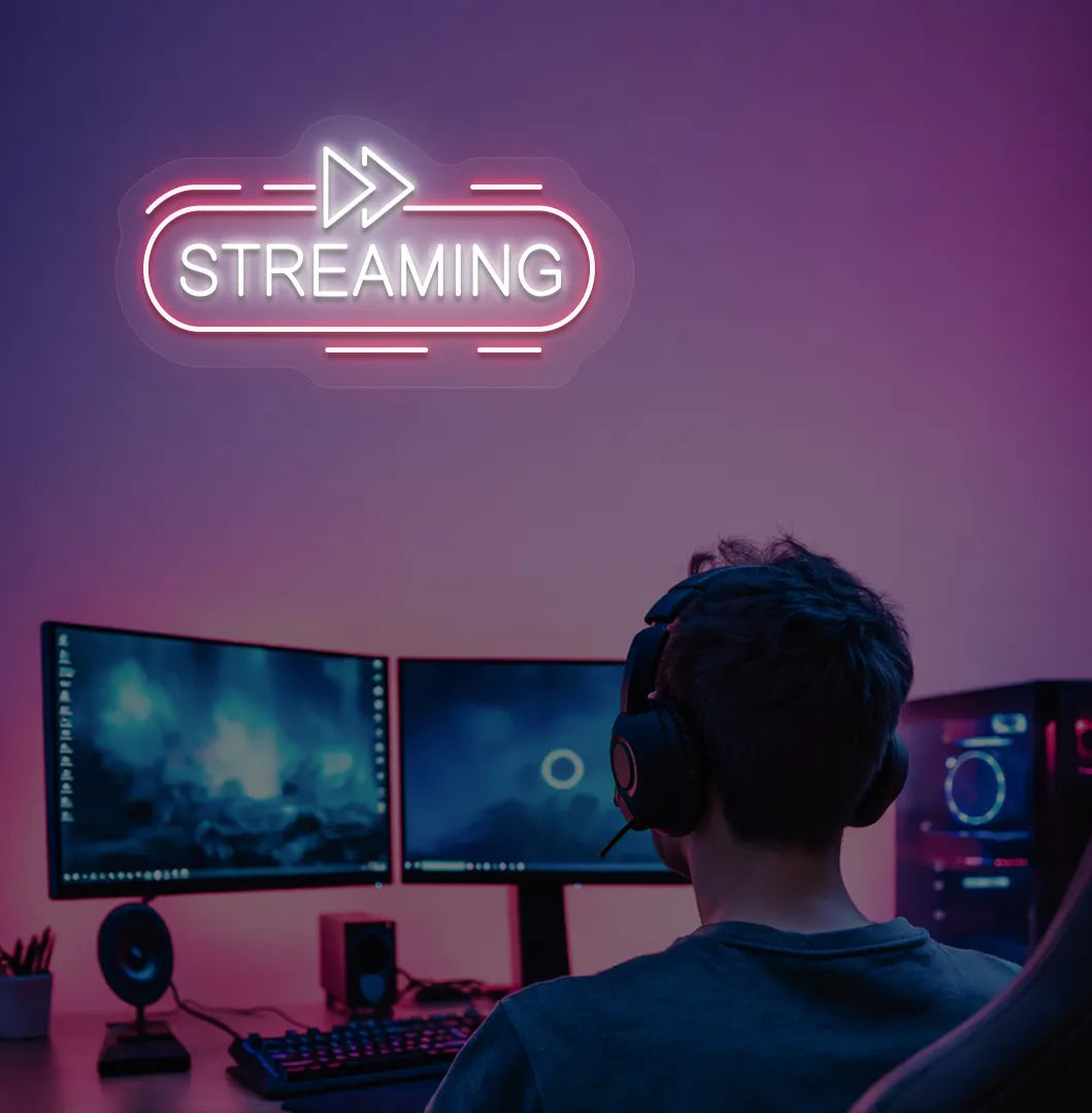 Image of a "streaming" neon sign in white color mounted on gaming room wall.