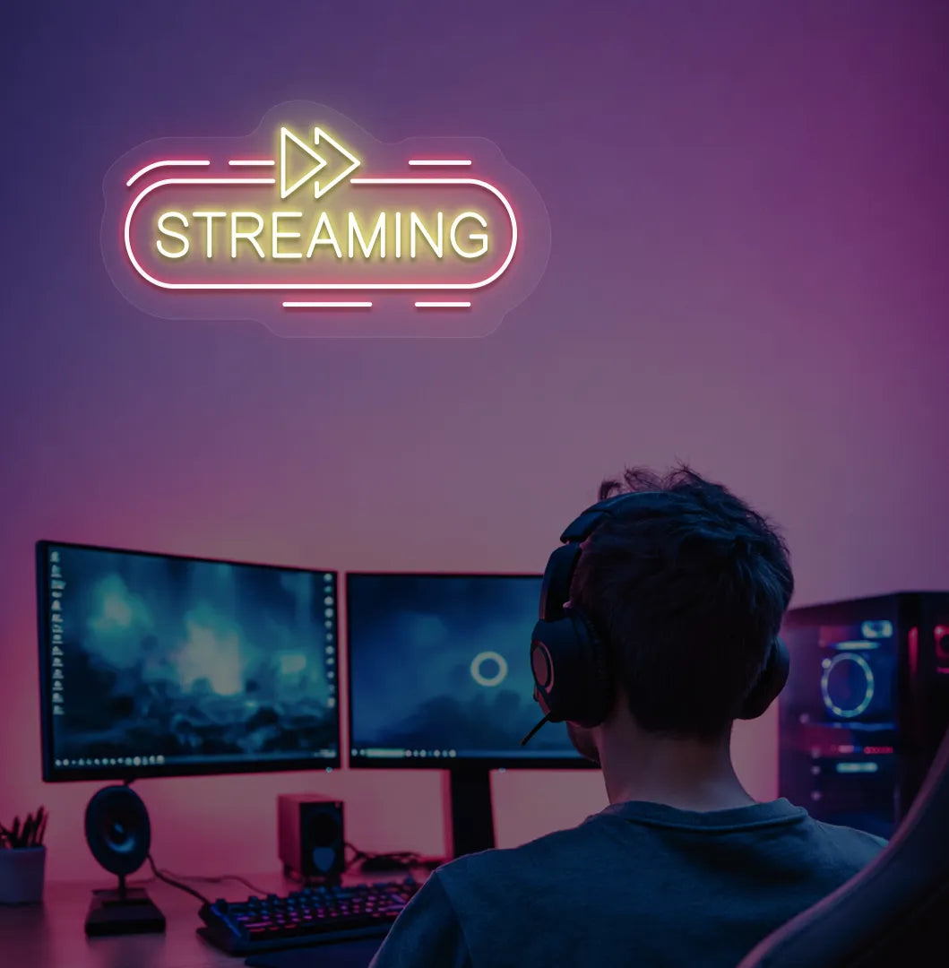Stylish streaming neon sign in yellow mounted on gaming room wall.