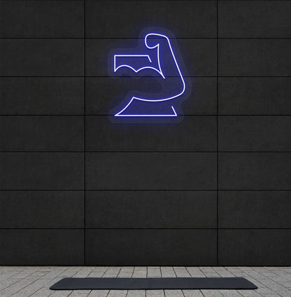 Image of a stylish strong body neon sign in blue mounted on gym wall.