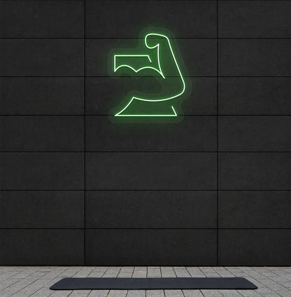 Trendy strong body neon sign in green mounted on fitness wall.