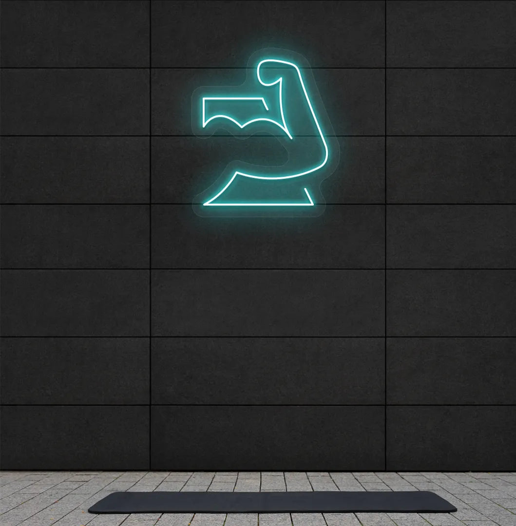 Image of a stylish strong body neon sign in ice blue mounted on gym wall.